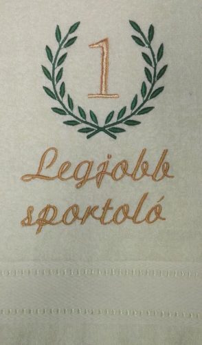 Krém hímzett „Legjobb sportoló” feliratú törölköző babérkoszorú mintával, sportolói ajándék