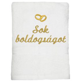 Fehér hímzett „Sok boldogságot” feliratú törölköző arany gyűrűkkel, esküvői ajándék